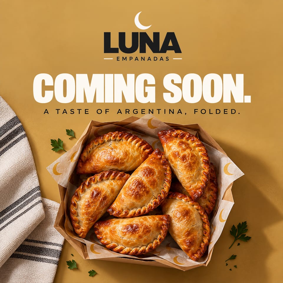 Luna Empanadas promotional graphic featuring a box of golden Argentine empanadas on a mustard background with “Coming Soon” text.