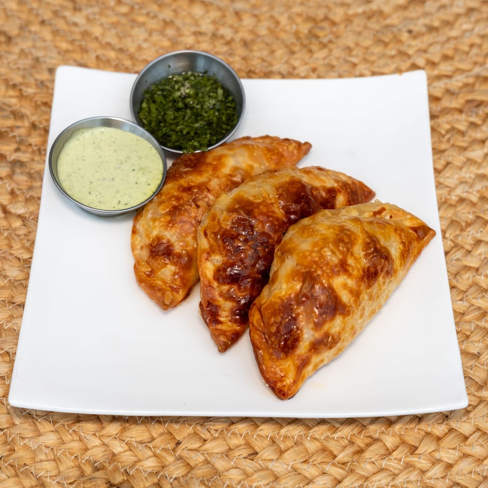 Vidalia onion and mozzarella empanadas with two dipping sauces.